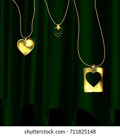 dark background, green drape and golden chain with three jewelry pendants heart