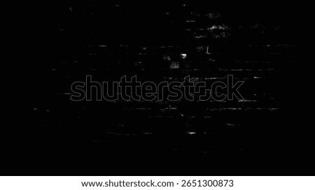 a dark and grainy image showing a brick wall with some light reflecting off the surface of the bricks here