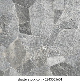 Dark gray stone tiles tightly packed, creating rough stone based texture