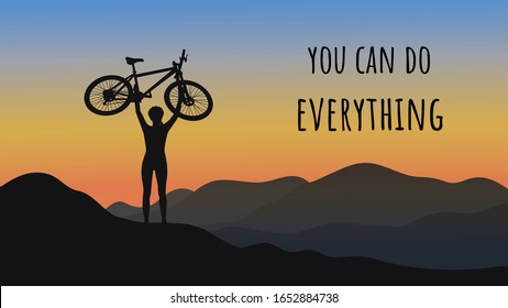 Dark silhouette of a cyclist on top of a mountain. The bike is raised above your head. Against the backdrop of a beautiful morning sky and mountain landscape. You can do everything