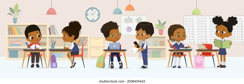 Dark skin children studying at multiracial elementary school sitting at tables talking together at classroom vector flat illustration. Diverse schoolboy and schoolgirl classmates wearing uniform