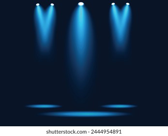 A dark stage with spotlight blue lights on the top