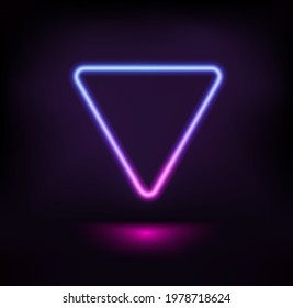 Dark stage with vibrant neon triangle