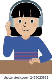 A dark-haired Japanese woman wearing long-sleeved clothes wearing headphones in front of a desk