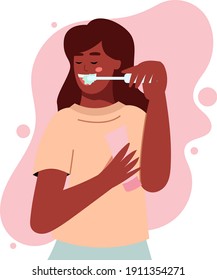 Dark-skinned African-American girl brushing her teeth with paste and brush, dental hygiene, morning routine in the bathroom