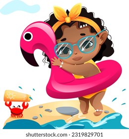 A dark-skinned girl with glasses stands on a beach with a pink circle of flamingos. The girl is afraid to swim.
