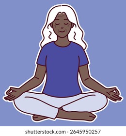 Dark-skinned senior woman sits calmly in lotus pose with closed eyes, practicing meditation and breathing for wellness and mental clarity