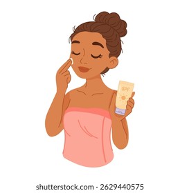 Dark-skinned woman applying SPF sunscreen to her face