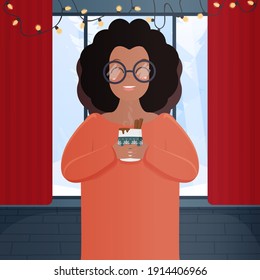 A dark-skinned woman with a hot drink in a room with a large panoramic window. African American girl with glasses holds a cup in her hands. Flat style. New Year and Christmas concept. Vector.