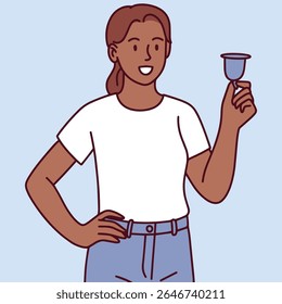 Dark-skinned woman stands holding menstrual cup confidently. Modern approach to feminine hygiene and reusable menstrual care