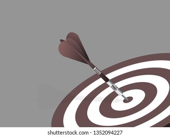 Dart arrow hitting in the target center of dartboard