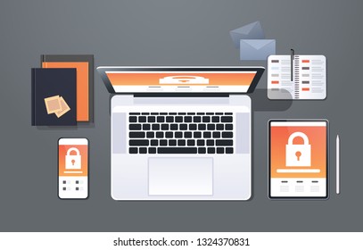 data protection internet security padlock privacy information safety concept top angle view desktop laptop tablet smartphone screen secured access office stuff horizontal