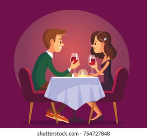 Dating. Valentines day celebration. Sweet happy young couple having romantic dinner with glasses of red wine on date.Drink wine.Christmas evening celebration.Pair couple together at  the dinner table.