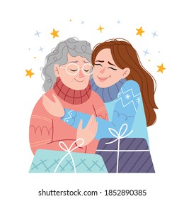 The daughter hugs her mother and wishes her a Merry Christmas and a Happy New Year. Family holiday.Christmas at home. Traditions