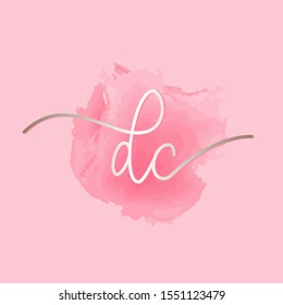DC monogram logo.Signature style typographic icon with script letter d and letter c.Shiny metallic lettering sign isolated on pink watercolor fund.Calligraphic alphabet initials.Modern,elegant style.
