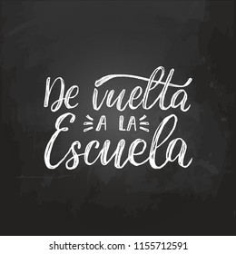 De Vuelta A La Escuela, vector hand lettering. Translation from Spanish to English of phrase Back To School. Calligraphic inscription on chalkboard background.