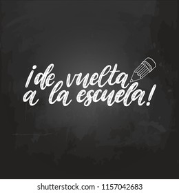 De Vuelta A La Escuela, vector hand lettering. Translation from Spanish to English of phrase Back To School. Calligraphic inscription on chalkboard background.