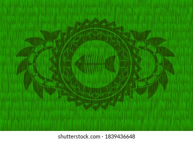 dead fish icon inside green grama grass emblem.   Eco exquisite background. Intense illustration. 