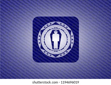 dead man in his coffin icon inside badge with denim texture