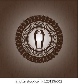 dead man in his coffin icon inside badge with wooden background