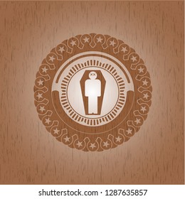 dead man in his coffin icon inside wooden emblem. Vintage.