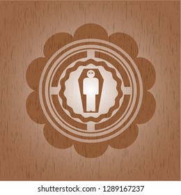 dead man in his coffin icon inside wooden emblem. Vintage.
