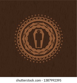 dead man in his coffin icon inside wooden emblem. Vintage.