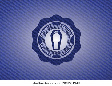 dead man in his coffin icon inside badge with denim texture