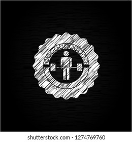 deadlift icon inside chalk emblem written on a blackboard