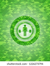 deadlift icon inside green emblem with mosaic background
