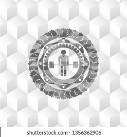 deadlift icon inside grey emblem with geometric cube white background