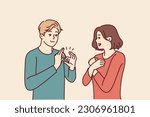 Deaf-mute man and woman are talking using sign language and demonstrating symbols with hands. Guy teaches girl sign language for concept of inclusiveness and socialization of people with disabilities