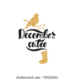 December cutie. Hand drawn calligraphy text. Holiday typography design with bullfinch and sock. Black and gold christmas greeting card. Vector illustration EPS10.