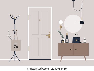 A decorated apartment entryway, a coat rack, and a mirror on the wall