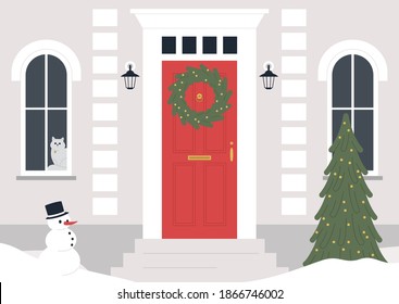 A decorated building entrance, a Christmas wreath on the door, a Xmas tree, winter holidays