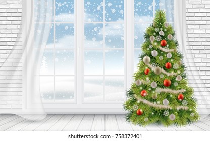 Decorated Christmas tree in the interior of a light living room on the background of a large window.
