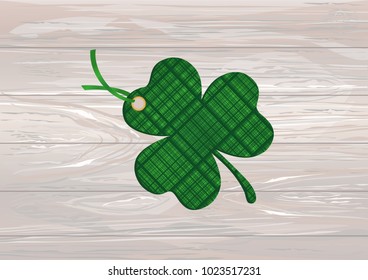 Decorated with a clover pattern tied with green ribbon. St.Patrick 's Day. Vector illustration. Greeting card with empty space for text or advertising. On a wooden background.