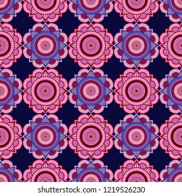 Decorative abstract pattern consists of mandala in red, pink and blue hues on the dark background, seamless vector as a fabric texture