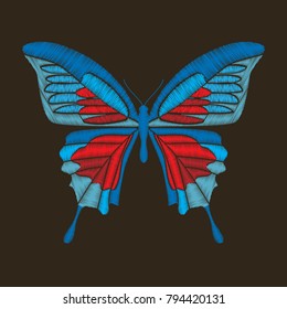 Decorative blue and red butterfly. Isolated on dark brown background. Vector embroidery element for patches, badges and stickers.