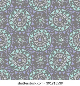 Decorative boho seamless pattern. Endless print with blue, green and yellow round ornaments on grey background. Colorful repeating tribal artistic backdrop. Cloth design, wallpaper, wrapping