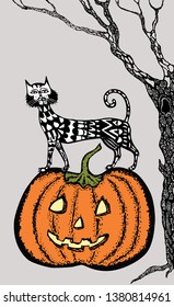 A decorative cat on a Halloween pumpkin