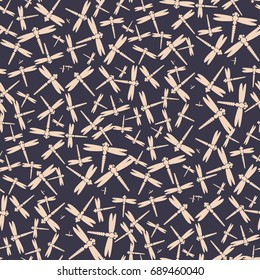 Decorative colored seamless pattern with cute dragonfly. Vintage background with many dragonflies silhouettes for your design.