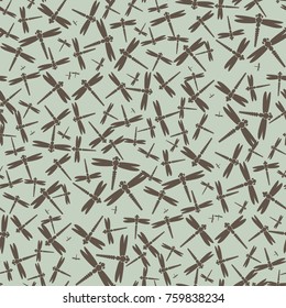 Decorative colored seamless pattern with cute dragonfly. Vintage background with many dragonflies silhouettes for your design.