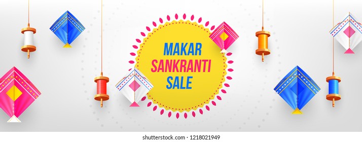 Decorative colorful spools and kites on glossy gray background for celebration of Makar Sankranti festival. Website header or banner design.