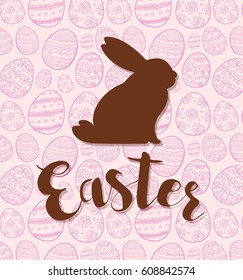 Decorative Easter greeting card with silhouette of rabbit on a pink background. 