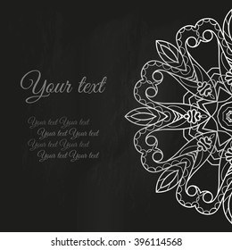 Decorative flower drawing with chalk on a blackboard. Card with lacy napkin and a place for your text.