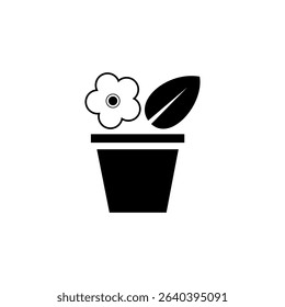 Decorative flower pot with a blooming flower and a leaf placed against a plain background