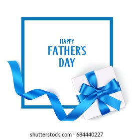 Decorative gift box with blue bow and long ribbon. Happy Father's Day text. Top view. Holiday template