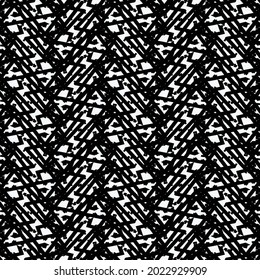 Gráficos decorativos resultantes de líneas rectas, rotas o entrelazadas y diversos signos o partículas. Alfombra de rayas, tejida en blanco y negro.