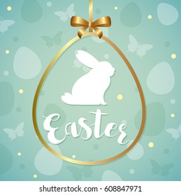 Decorative green Easter greeting card with silhouette of white rabbit in golden frame. 